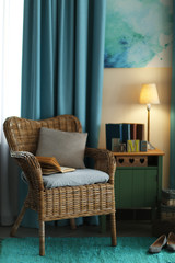 Design interior with wicker armchair and wooden nightstand indoors