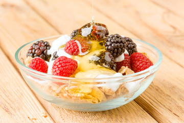 breakfast cereal bowl with berries and yogurt