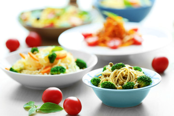 Different cold pasta salads in bowls on the table closeup