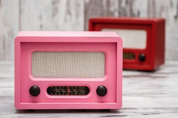 Pink Radio with Retro Look on White Wooden Background