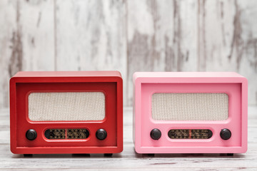 Pink and Red Radio with Retro Look on White Wooden Background