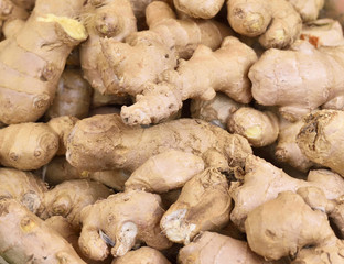 Fresh ginger at a market stall. Selective focus of ginger in a wooden box at a market stall. 