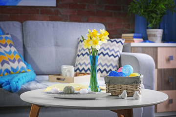 Design interior of living room with fresh narcissus flowers