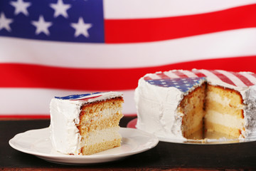 Piece of American flag cake, on black wooden table.