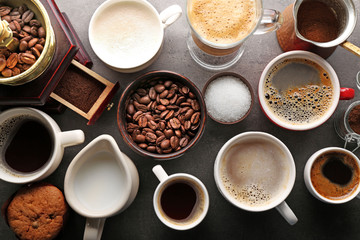 Different types of coffee in cups on dark table, top view - Powered by Adobe