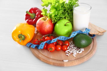 Set of fresh fruits and vegetables on wooden table closeup