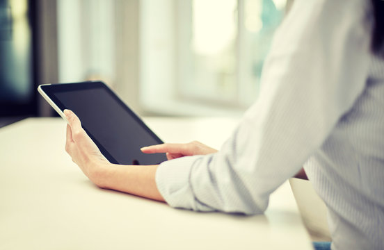 close up of woman hands with tablet pc at office