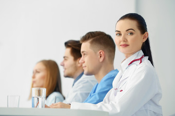 Fototapeta premium Medical doctors sitting at the meeting in modern hospital