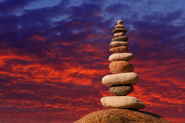 Fototapeta na wymiar Concept of harmony and balance. Rock Zen on sunset background.