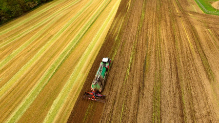 Tractor with Liquid Manure Spreader on field - Aerial view 