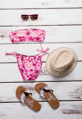 Fototapeta na wymiar Pink swimsuit with beige hat.