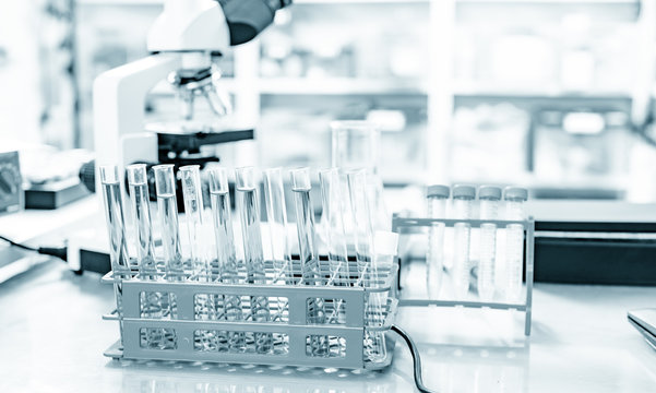 Microscope And Test Tubes On Laboratory Bench