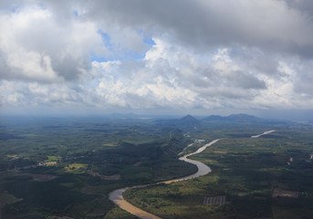 aerial top view from air plane see river and green hills field with clear white cumulus cloud and cloudscape on blue sky