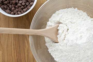 cropped image of bowl with flour and spatula.