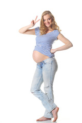 pregnant woman caressing her belly over white background. Positive pregnant woman showing fingers the letter 