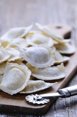 Homemade ravioli on wooden board