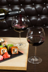 sushi mix  served dinner, red wine on table at restaurant