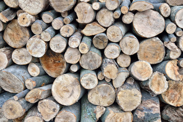 Pile of wood logs ready for winter. Stack of firewood as backgro