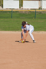 Female softball player playing defense on the infield. © motionshooter