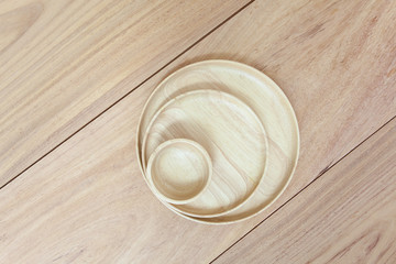 Empty round wooden plate on wood table background