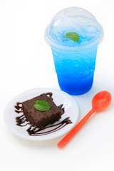 Italian soda with chocolate cake on white background