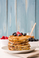 Pancakes with raspberries, blueberries and honey
