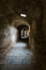 Obraz premium Roman amphitheater of Italica in Santiponce. Sevilla. Spain. Interior corridor under the bleachers.