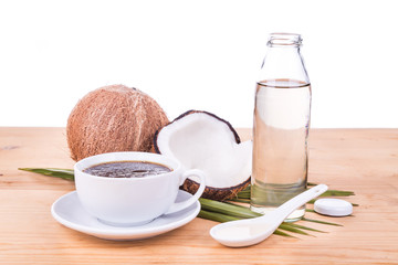 Bulletproof coffee with cold pressed extra virgin coconut oil on wooden table isolated in white, part of ketogenic diet
