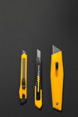 Paper cutter, office equipment, box cutter isolated against a bl