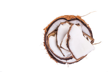 Old brown organic coconut fruit broken into pieces and stacked