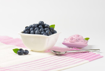 Bowl of fresh blueberries and yogurt
