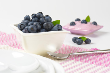 Bowl of fresh blueberries and yogurt