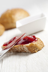 bread with a spread of strawberry jam