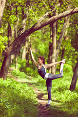 Young girl doing yoga in the park.
