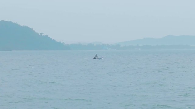 Single fishing boat on the beach. Beautiful shot zoom in .Thailand