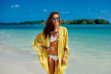 Beautiful pretty woman in bikini on tropical paradise beach