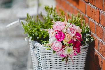 Wedding bouquet of pink peonies in a white basket