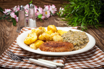 Delicious meal of minced meat cutlet, potatoes and fried cabbage