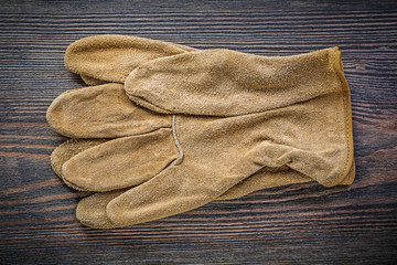 Pair of working gloves on vintage wooden board directly above ag