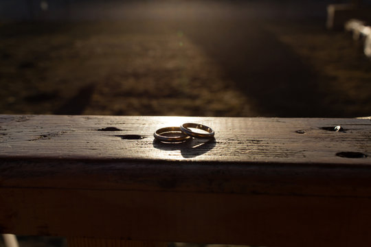 Silver wedding rings at sunset