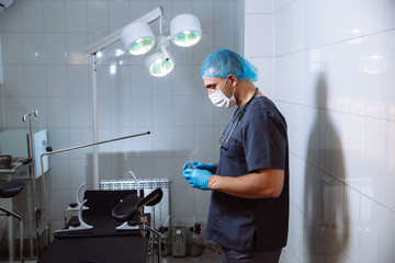 Surgeon man in operating room with medical tools want to puts gl