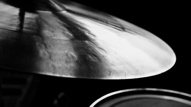 Cymbal being played / Close up of a cymbal as it is being played in black and white videography