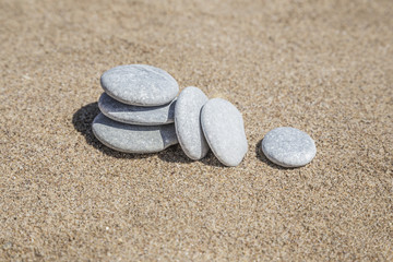 Fototapeta na wymiar pebble stones on sand