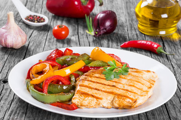 Grilled Chicken breast fillet and fried bell pepper , clos- up