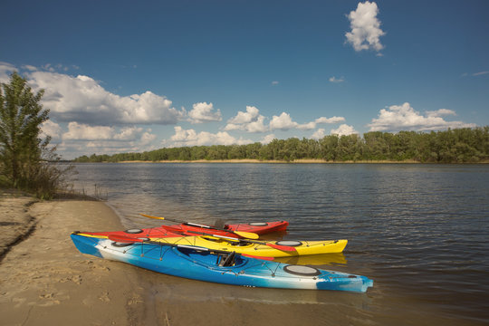 Camping with kayaks on the beach on a sunny day.