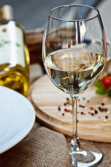A glass of white wine stands on a table in the restaurant