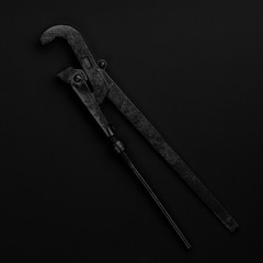 Black & white adjustable gas key isolated on black background. S