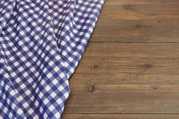 Zelfklevend Fotobehang Rustic Picnic Wooden Table With Blue Folded Checkered Tablecloth © Alex
