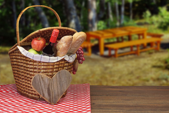 Picnic Basket With Wine Bottle, Bread And Fruits On  Table