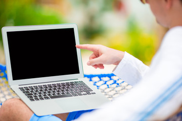 Closeup laptop at male hands outdoors